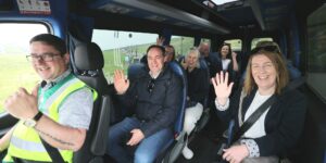 Photo of people smiling and waving while on the Burren & Cliffs Explorer