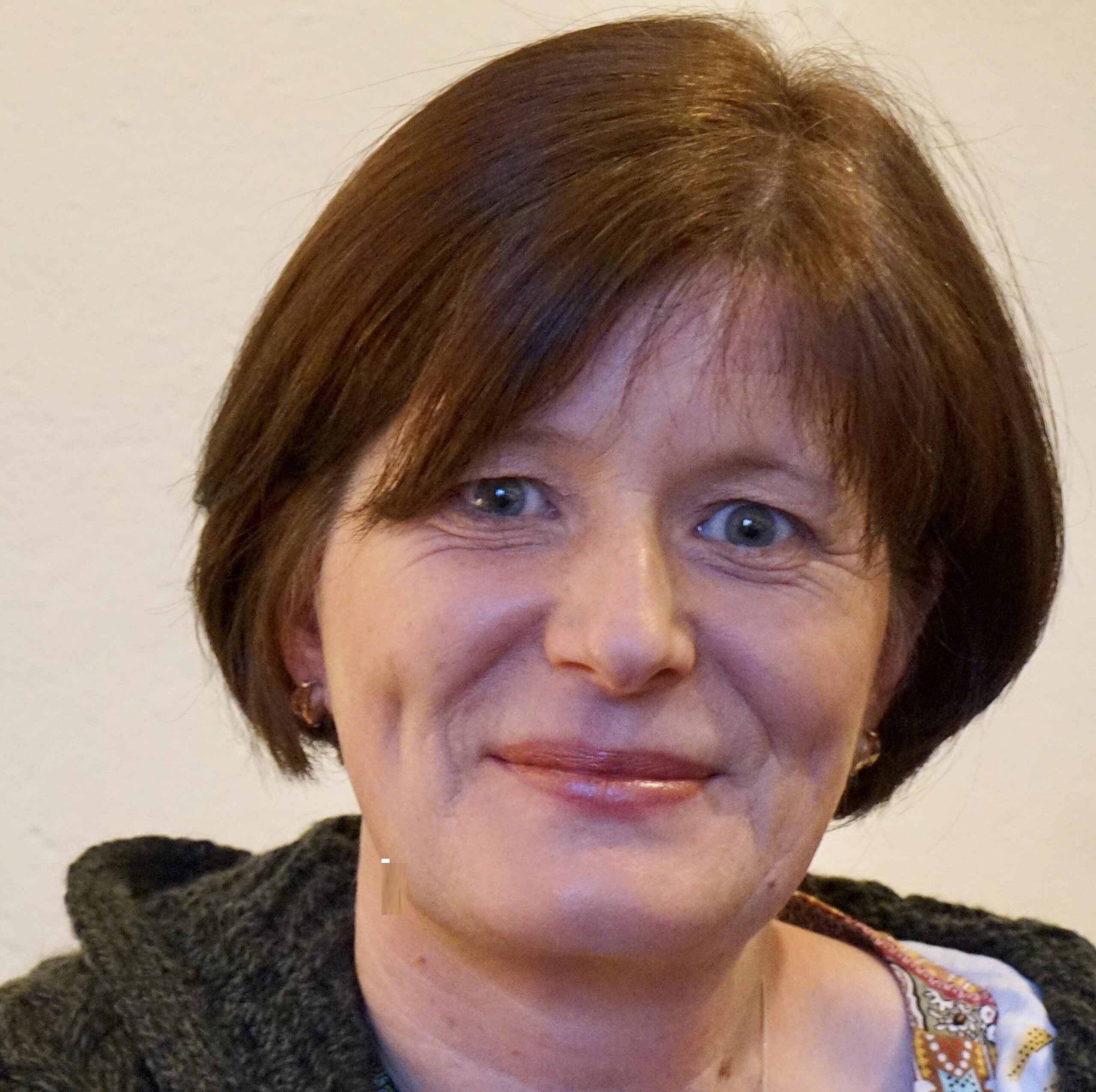 Portrait of celebrant, Bríd O’Donoghue. Woman with short brown hair and blue eyes.